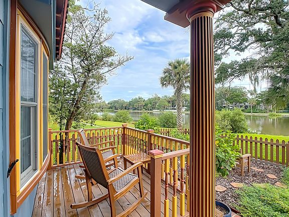Rocking chairs on deck, overlooking lake.
