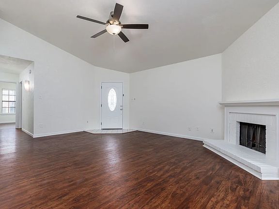 View of living room showing front door and hall to bedrooms.