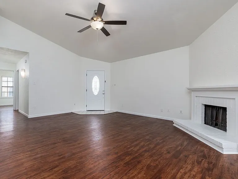 View of living room showing front door and hall to bedrooms.