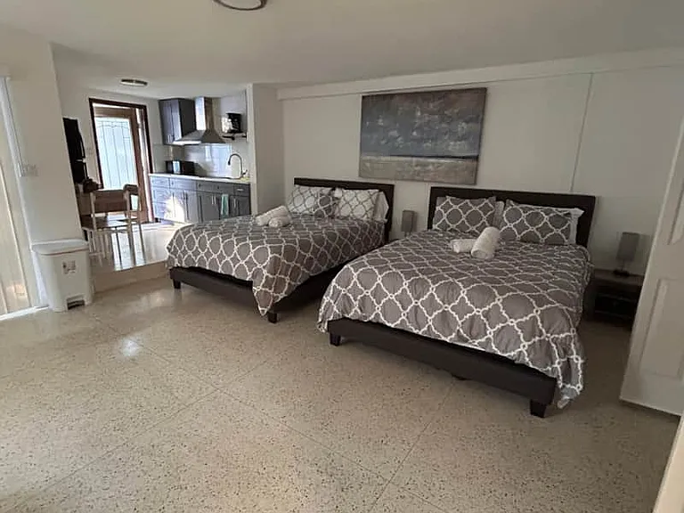 Modern studio with 2 queen beds, full kitchen & essentials included.