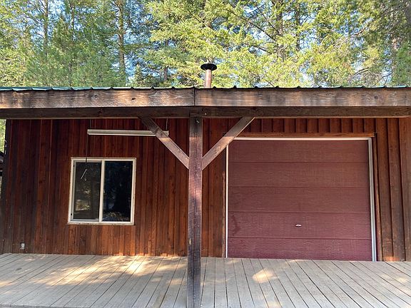 Guest shed has wood burning stove, Refrigerator, make shift kitchen. The water is turned off to the bathroom sink and toilet.
