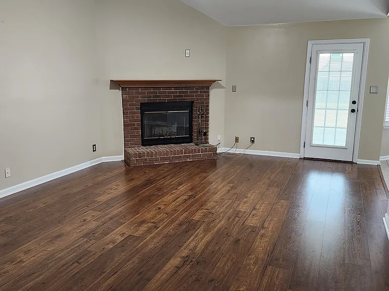 Beautiful view of "Great Room", mantel/fireplace; new floors, shiny and comfortable atmosphere; modern ceiling fan.