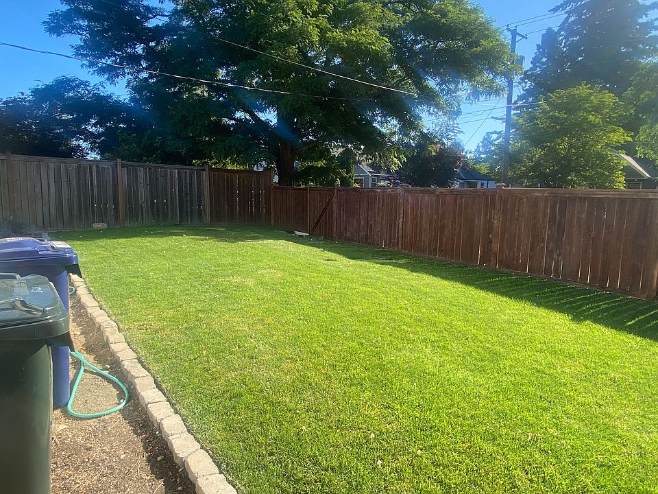 Recently laid in lawn surrounded by fence. Complete with sprinkler system.