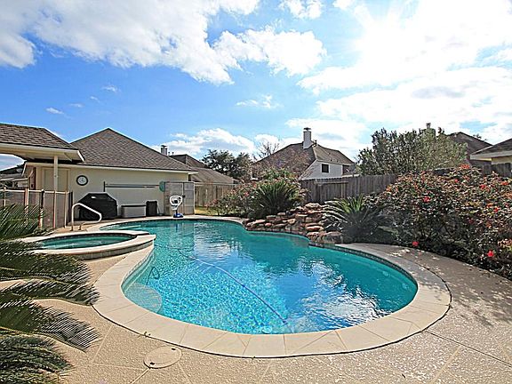THIS BEAUTIFUL HOME ON A CUL-DE-SAC LOT BOASTS A SPARKLING POOL WITH WATERFALL AND SPA