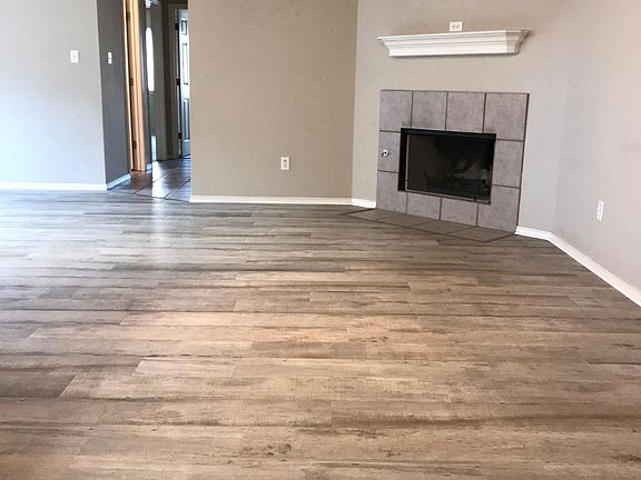 Walk in the front door and you're greeted with this spacious living room and corner fireplace. The open concept between kitchen & living room is perfect for entertaining guests and watching the big game!