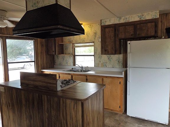 Lots of windows! Refrigerator with ice maker, gas stove.