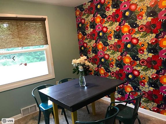 Dining room with stylish Anthropologie wallpaper