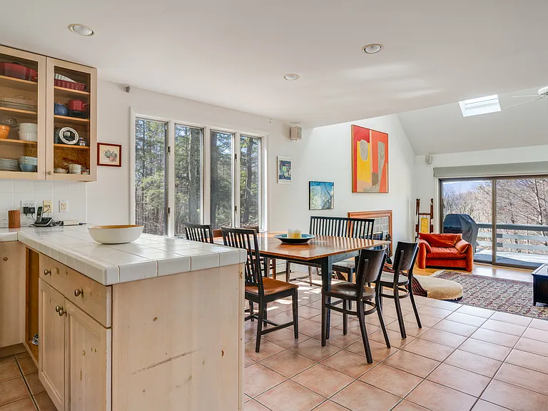 Open concept kitchen, dining area, and living room, all looking out to the generous deck.