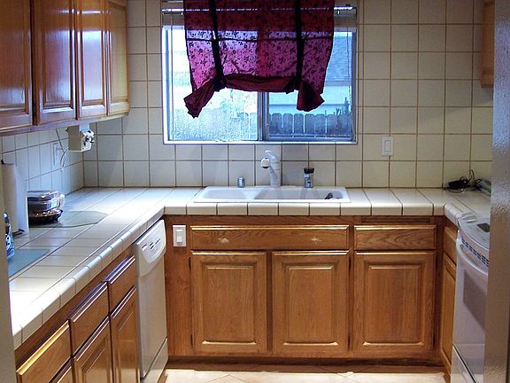 Updated Kitchen with newer appliances, nice cupboards and tile cntrs & flrs