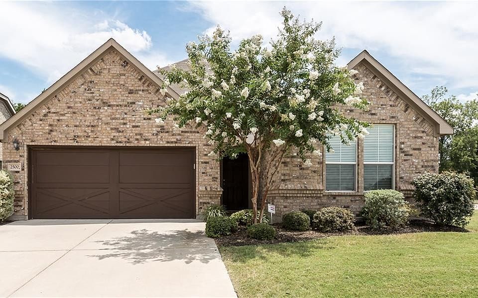 Beautifully landscaped and well manicured single-story home.