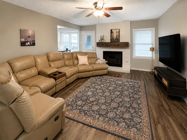 Cozy living room with a fireplace and large TV. Relax and unwind after a long day of work.