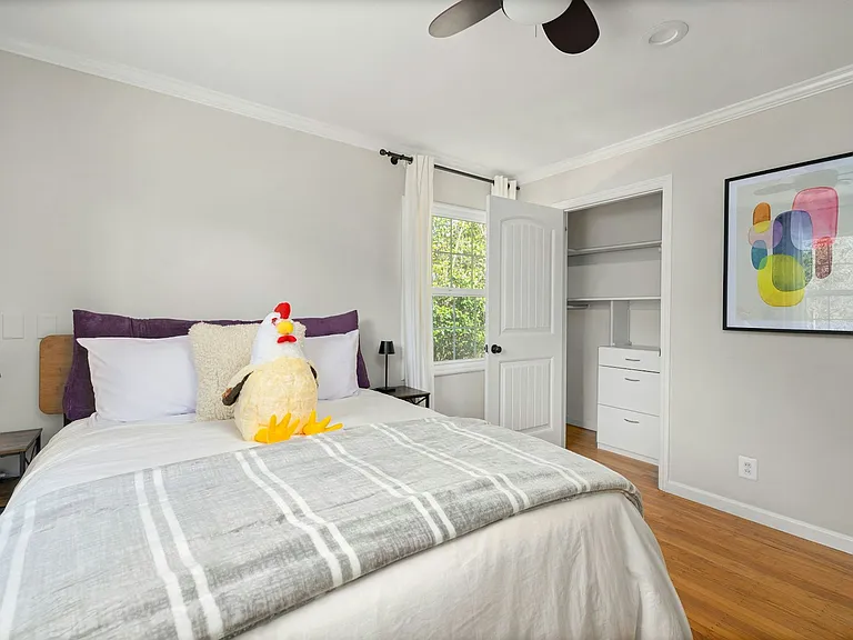 Cozy, colorful, and full of charm with built-in storage, a fun touch of personality, and great natural light, this bedroom is perfect for kids, guests, or creative thinkers.