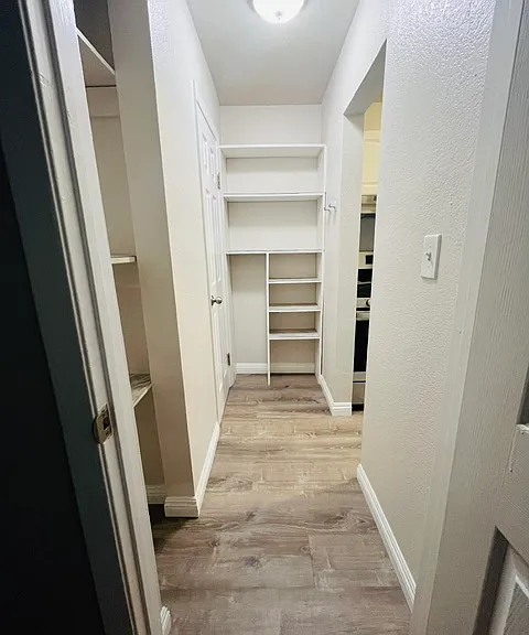 Hallway between kitchen and bathroom-two storage units