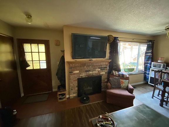 Den with TV over gas fireplace