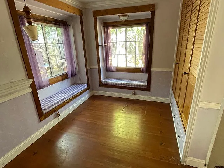 Main-level bedroom with two charming bay windows