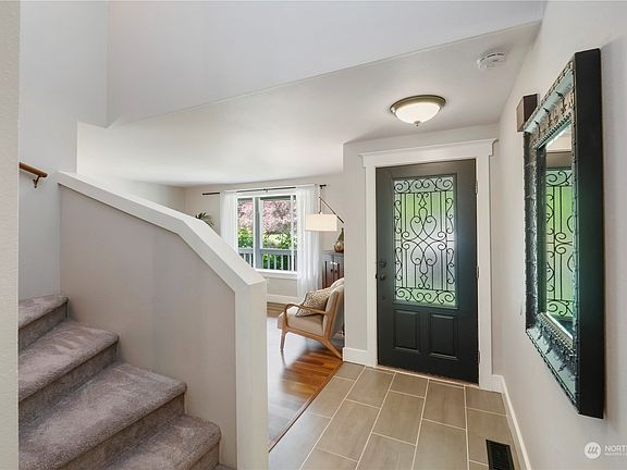 The entry features new Gallatin tile and expands into the kitchen and informal dining space>