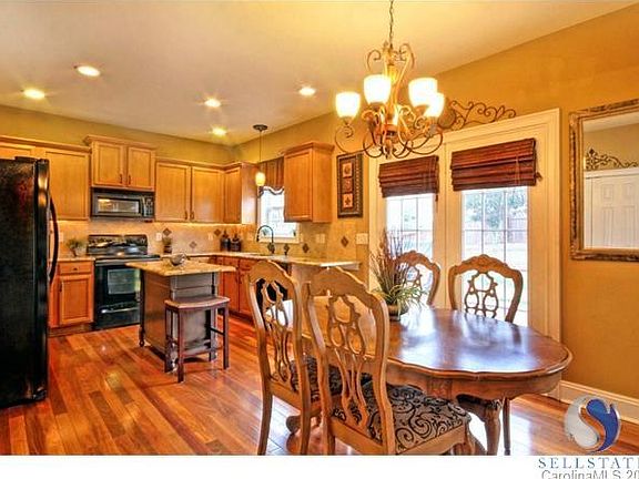 Hardwoods in kitchen. Lovely upgraded granite on counter tops and center island. French doors lead t