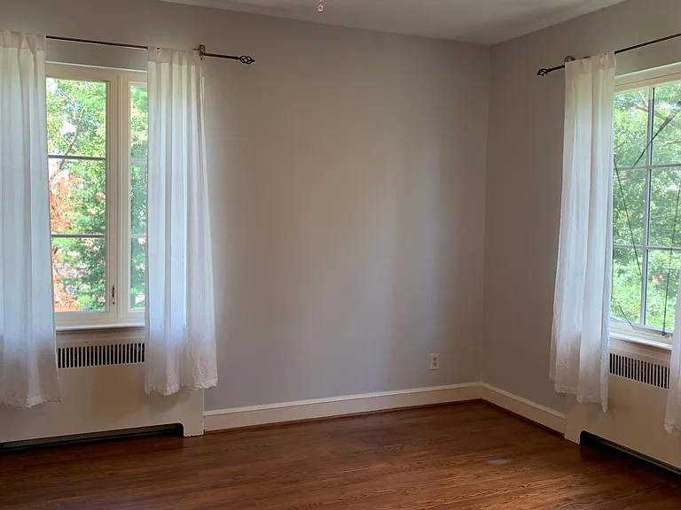 Bedroom on back side of house, overlooking back patio and driveway - two large windows and 2 closets. Floors redone in 2025. walls and ceilings reskimmed and painted in 2025