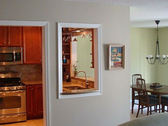 The renovated kitchen offers a passthrough window to the separate dining and living rooms.