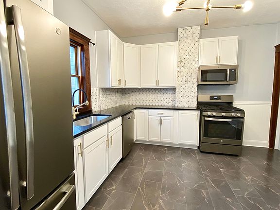 GE appliances in slate finish, including dishwasher and disposal