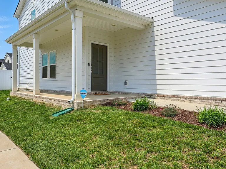 Charming wraparound front porch_perfect for relaxing or entertaining outdoors.