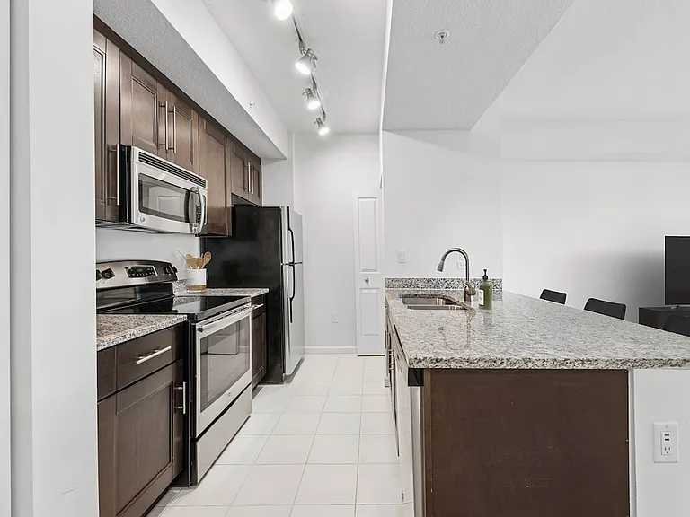 Classic Package kitchen with stainless steel appliances, granite countertops (in most homes), and oak cabinetry