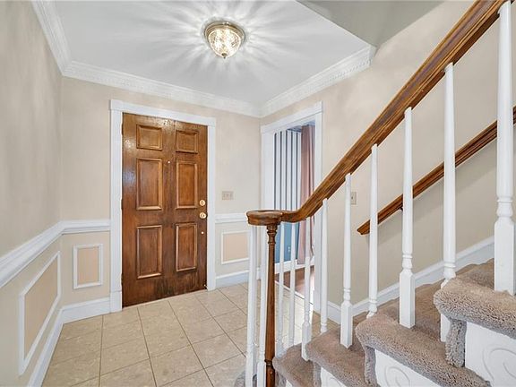 Lovely foyer with tile and trim.