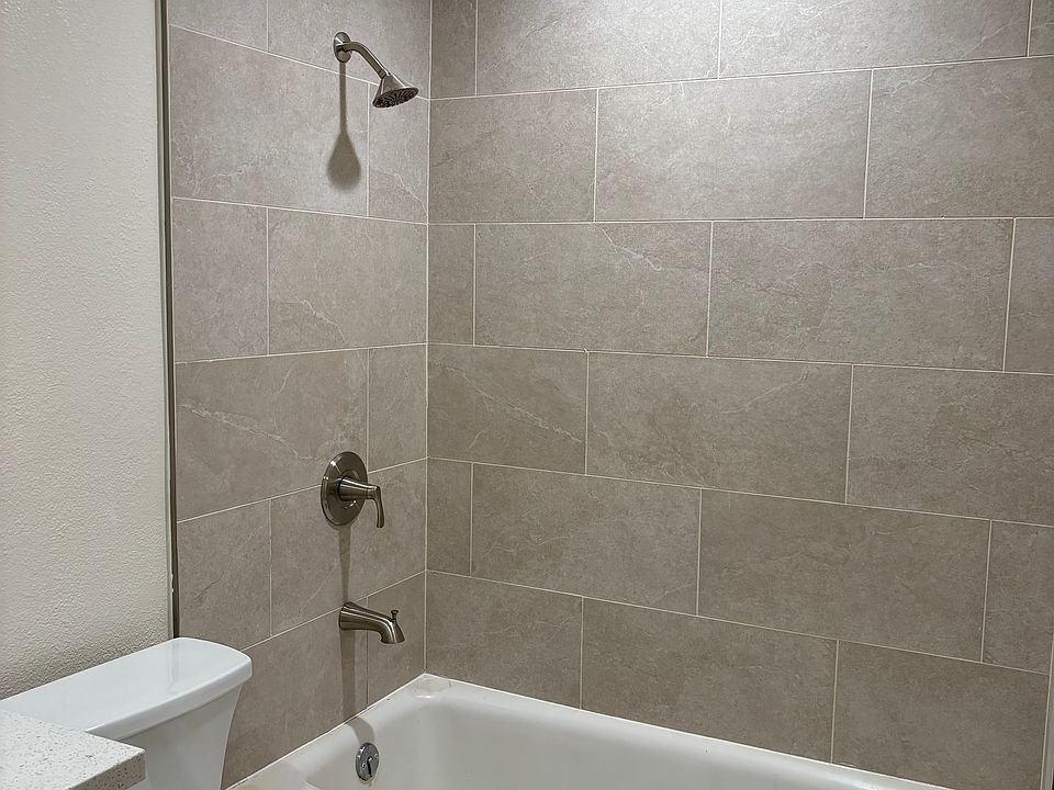 bathroom with new tile, fixtures, vanity and toilet