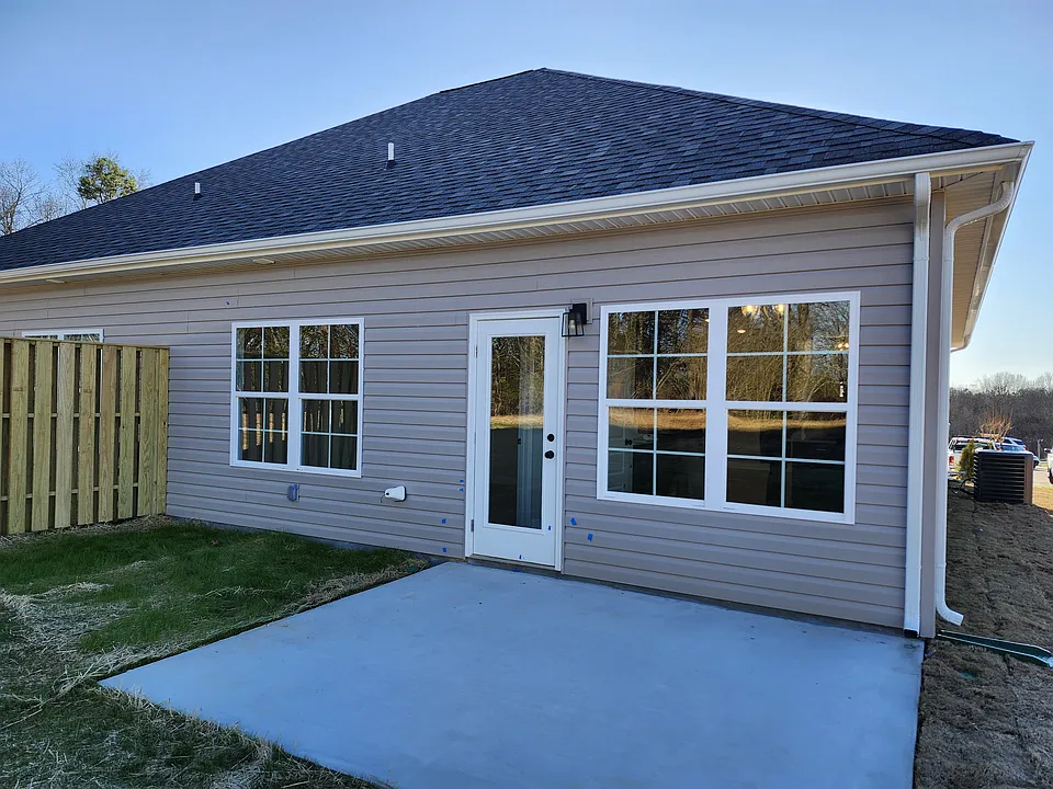 Back porch open up to a large back yard space, up to the tree line.