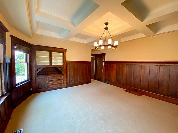 Dining Room with coffered ceiling, paneling and built-in china cabinet