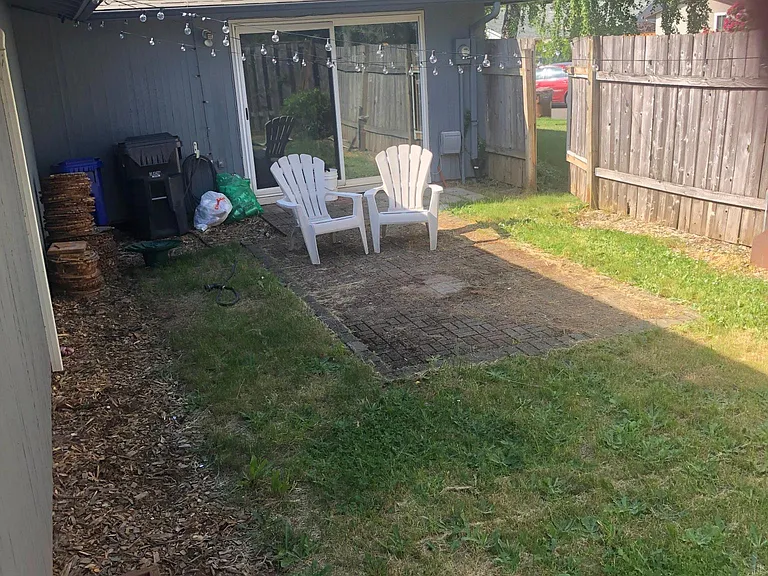 New fence & gate as of 2024. Courtyard off family/LR slider of 1032