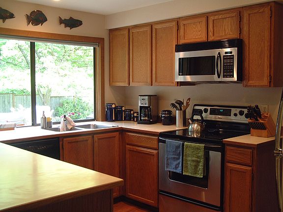 Kitchen faces woods and backyard