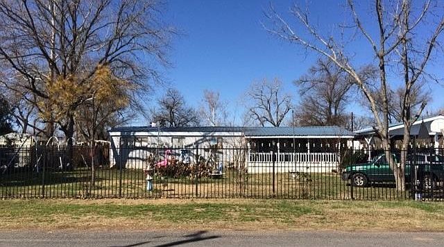 Exterior Front with Wrought Iron Fence
