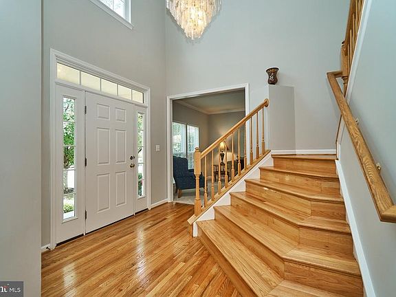 Two story foyer with beautiful hardwood flooring