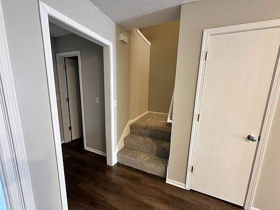 Standing inside by front door.