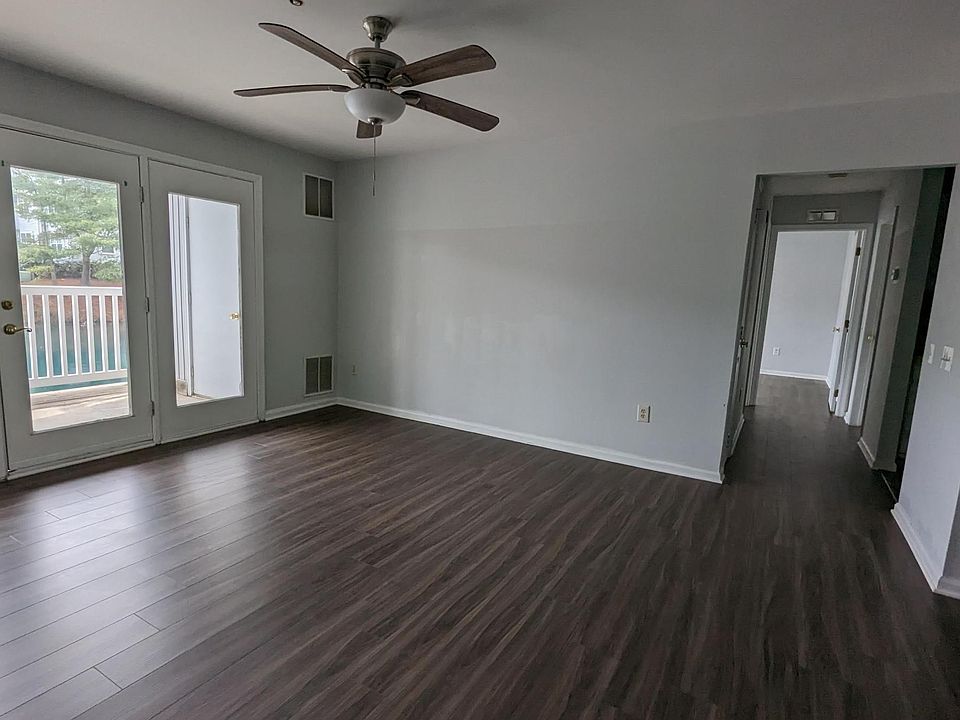 Spacious living area with glass patio door that allows ample sunlight in