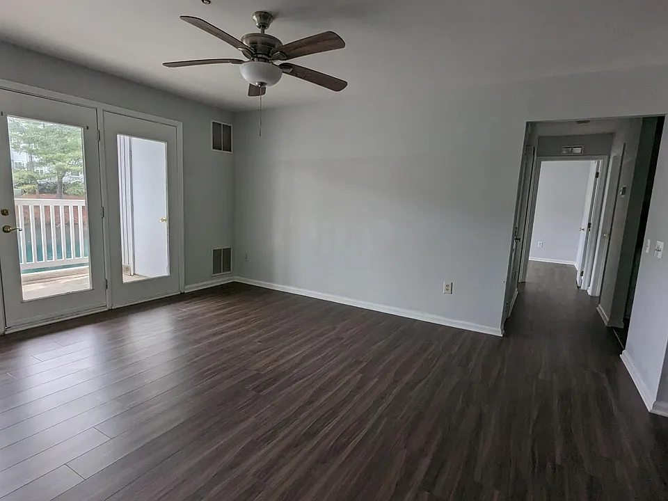 Spacious living area with glass patio door that allows ample sunlight in