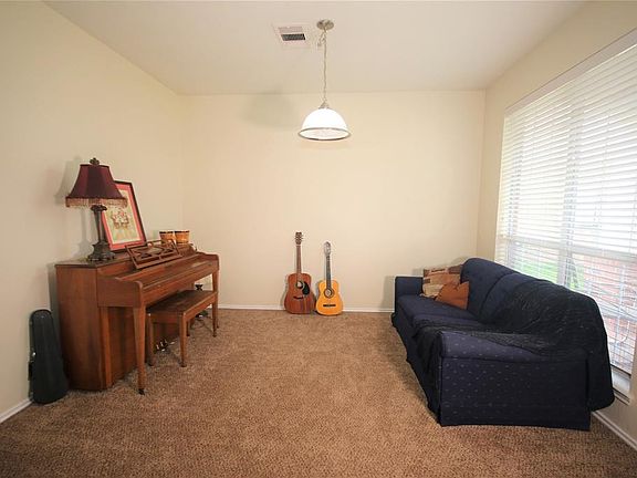 The front room off the entry is a convenient flex space. Currently used as a music room, it could serve as an office, a formal living room, a downstairs playroom, or a home-school room.