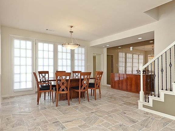 Perfect for casual or formal dining, the centrally located dining room features a wall of French doo