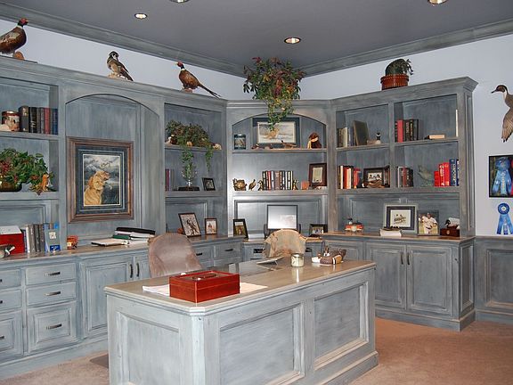 Private study with built-in bookcase and desk.