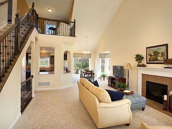 This unique home design features a family room with cathedral ceilings and an open floor plan flowin