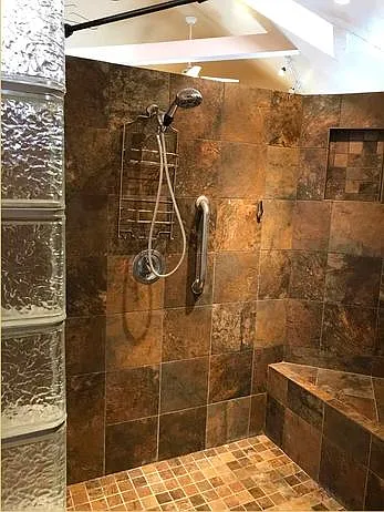 Walk-in shower with bench seating.