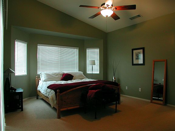 The vaulted ceilings continue into the master bedroom with bay window