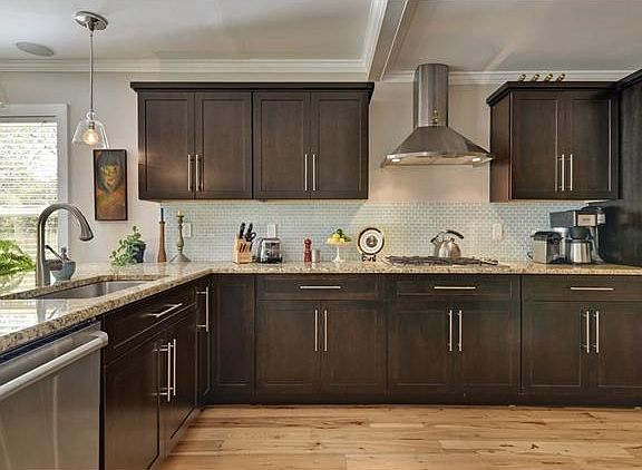 Attractive granite counter tops and high-end stainless appliances complete the welcoming kitchen.