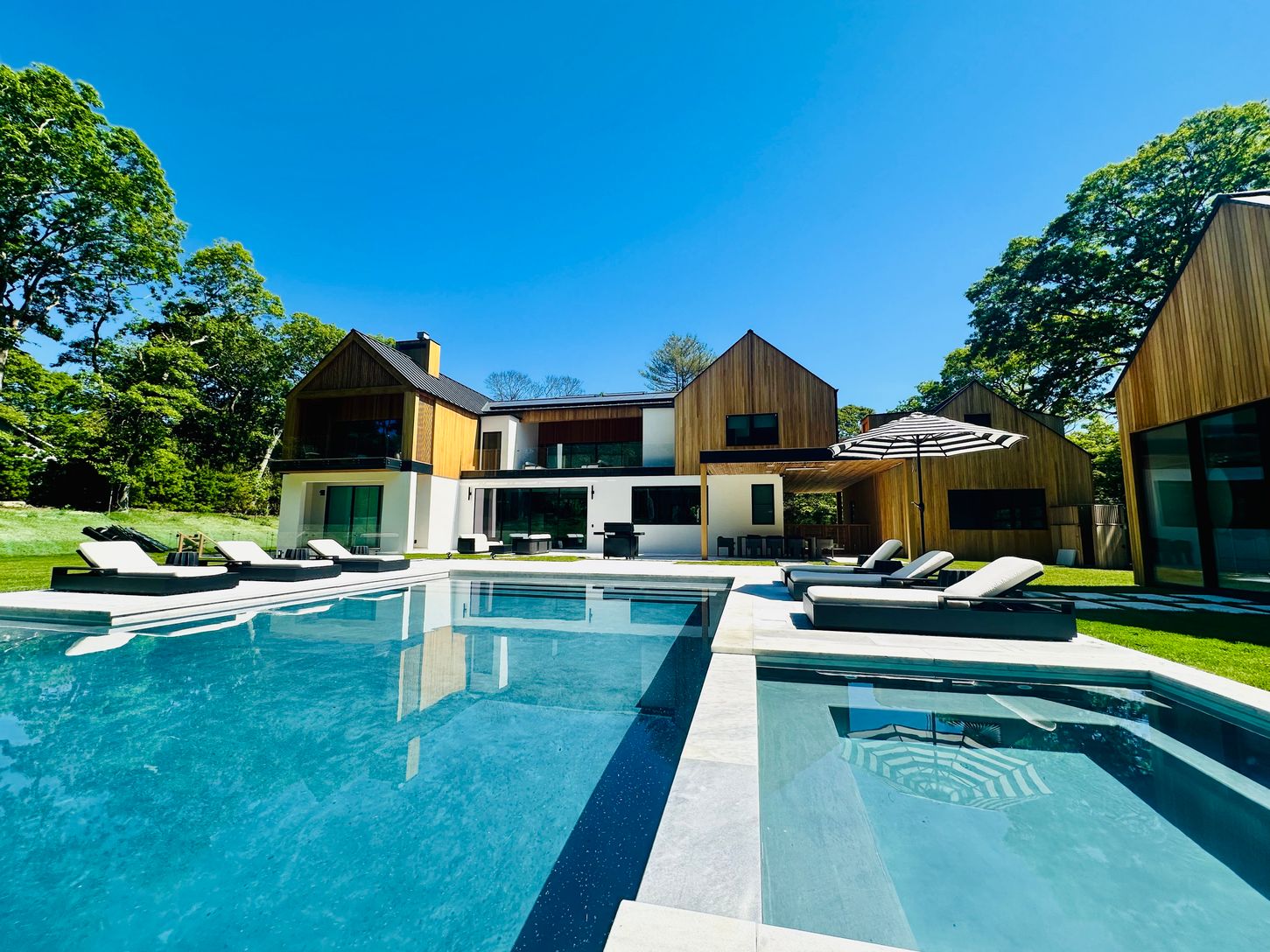  8 person jacuzzi with an infinity edge over the pool
