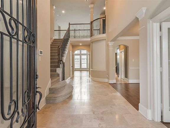Bright foyer with Travertine floors plus study and formal dining room to the right.