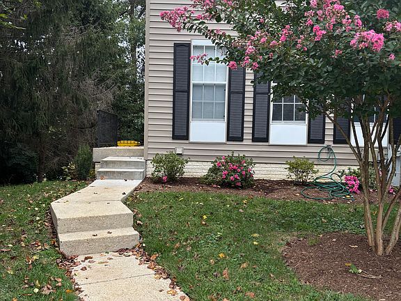 A fall season shot of the street facing side. Dead tree to the left was just taken down. Landscaping on the side as well