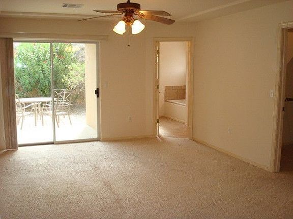 Master Bedroom Has Spacious Walk In Closet, Ceiling Fan and Sliding Glass Door Entryway to Patio.