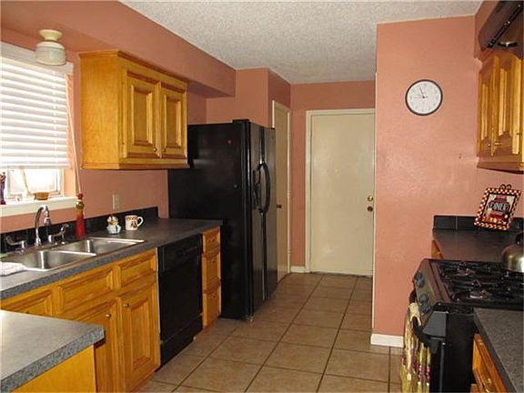 KITCHEN WITH UPDATED COUNTERS AND TILE FLOORING