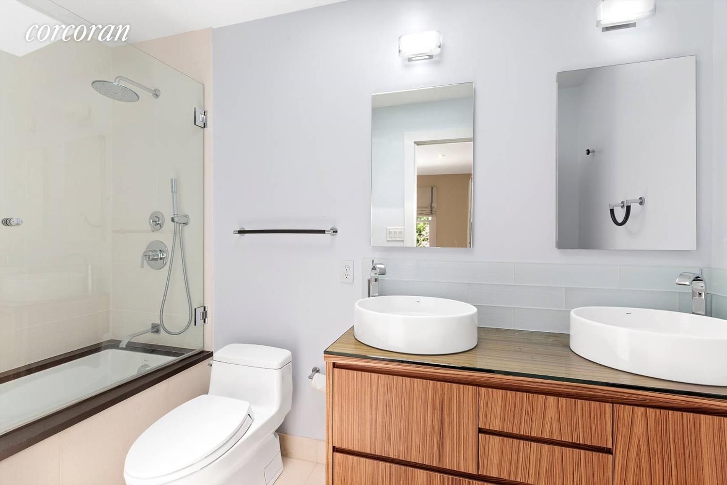  En-suite double sink bathroom with jacuzzi bathtub.